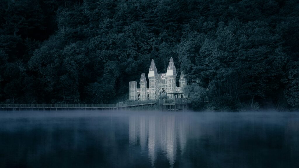 A castle reflected in a dark lake beneath a twilight sky